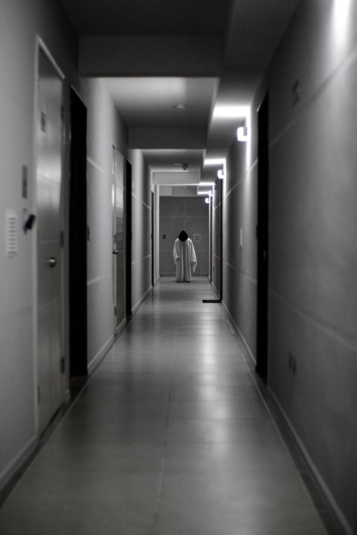 Crafting Captivating Headlines: Your awesome post title goes here A ghostly figure stands alone in a dimly lit hallway, creating a haunting atmosphere.